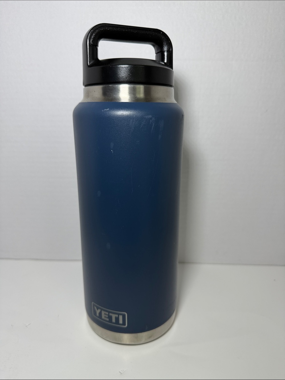 Yeti navy blue insulated water bottle with black handle